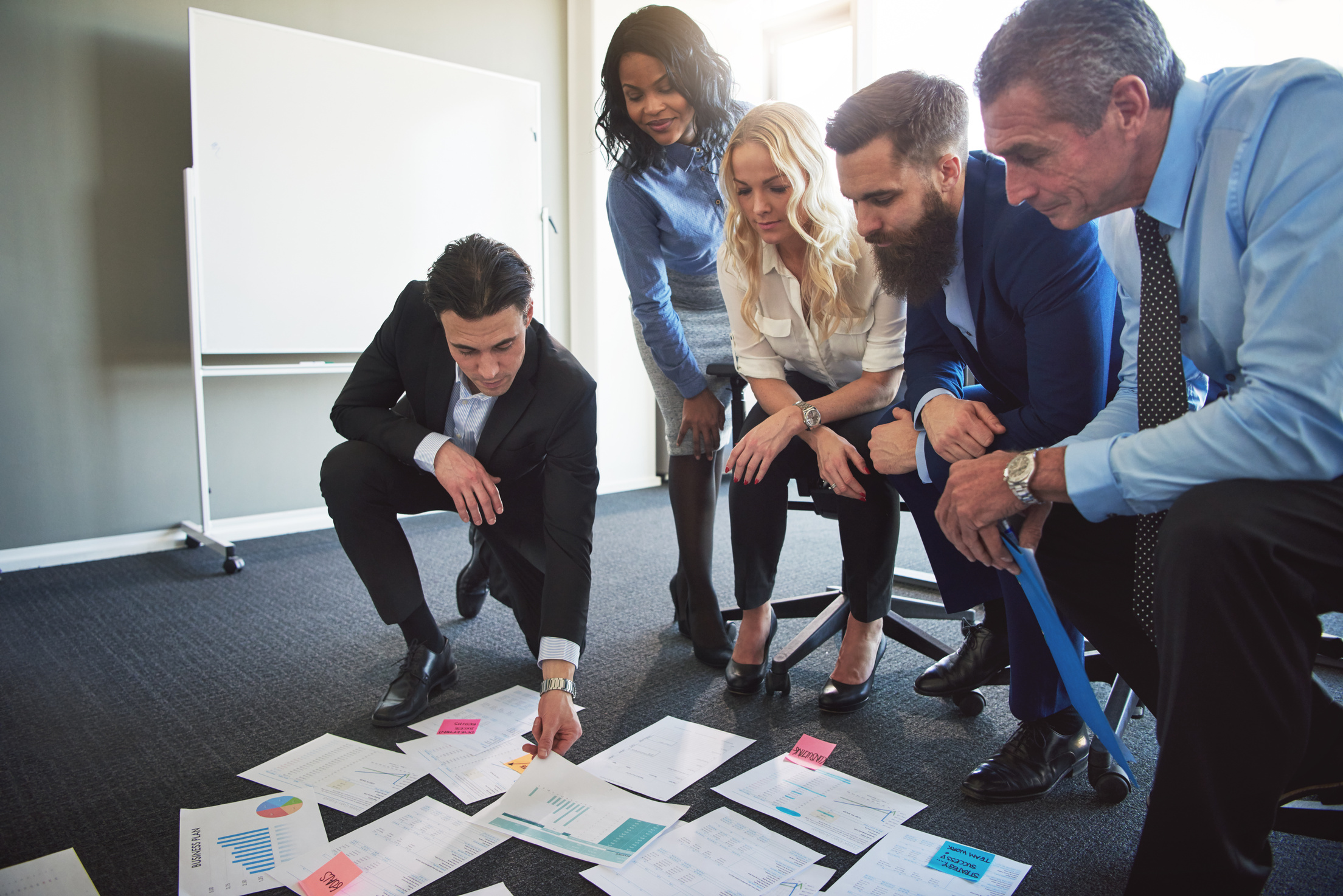 Businesspeople Planning and Strategizing with Documents in an of